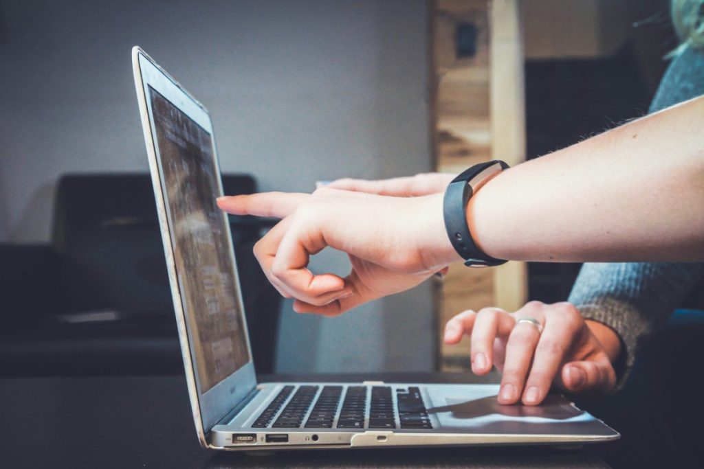Two people collaborating on a laptop to review automation workflows and software integration.
